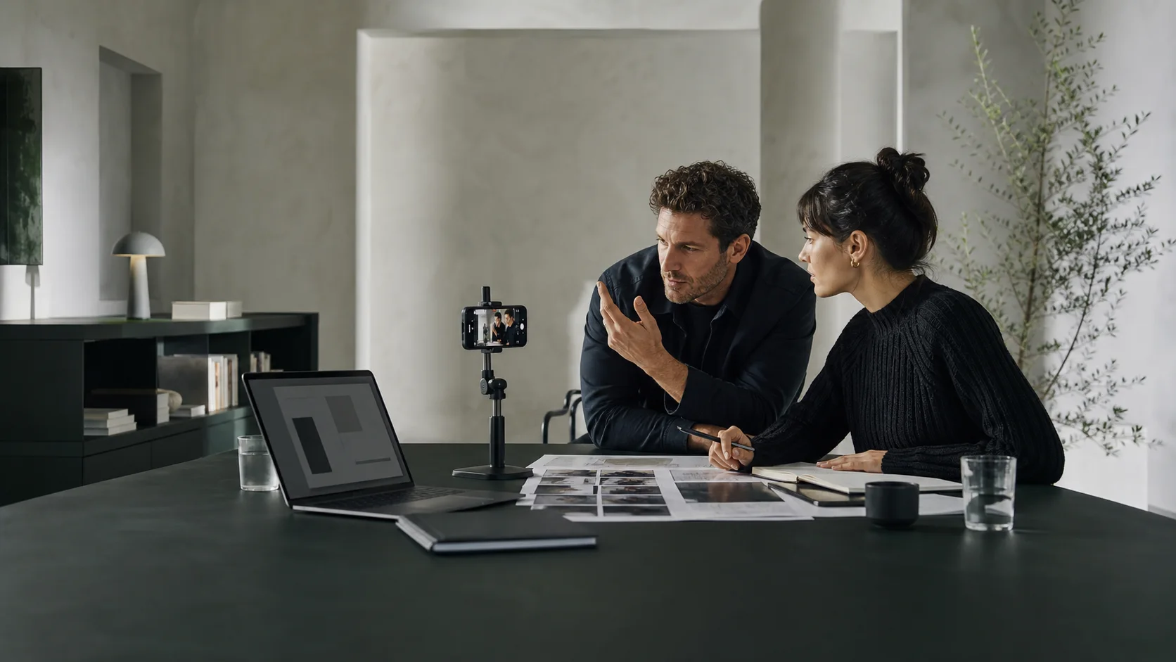 Creative director and creator reviewing a campaign plan beside a filming setup